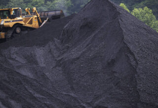 Obama's New Proposed Regulations On Coal Energy Production Met With Ire Through Kentucky's Coal Country SHELBIANA, KY - JUNE 3: A bulldozer operates atop a coal mound at the CCI Energy Slones Branch Terminal June 3, 2014 in Shelbiana, Kentucky. New regulations on carbon emissions proposed by the Obama administration have reportedly angered politicians on both sides of the aisle in energy-producing states such as Kentucky and West Virginia. (Photo by Luke Sharrett/Getty Images)